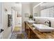 Bright bathroom featuring double sink vanity, modern fixtures, and decorative floor tiles at 946 Scotch Dr, Gastonia, NC 28054