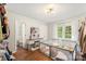 Bedroom with hardwood floors, vanity table, a playpen, and a nearby bathroom at 946 Scotch Dr, Gastonia, NC 28054