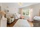 Well-lit Bedroom with hardwood floors featuring a glider, soft rug, crib and soft decor at 946 Scotch Dr, Gastonia, NC 28054