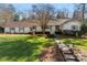 Charming single-story home with a well-manicured lawn, brick pathway, and mature landscaping at 946 Scotch Dr, Gastonia, NC 28054