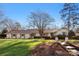 Charming single-story home with a well-manicured lawn, brick pathway, and mature landscaping at 946 Scotch Dr, Gastonia, NC 28054