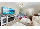 Cozy living room featuring a decorative fireplace, a large TV, and a festive Christmas tree at 946 Scotch Dr, Gastonia, NC 28054