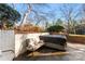 Enclosed backyard patio featuring a hot tub, brick accents, and outdoor seating under a sunny sky at 946 Scotch Dr, Gastonia, NC 28054