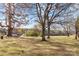 Large backyard with mature trees and open field beyond at 955 Goodnight Rd, Salisbury, NC 28147