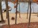 Scenic backyard featuring a sandy beach area with a fire pit and lake access at 1140 Inlet Pointe Rd, Salisbury, NC 28146