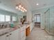 Elegant bathroom with dual sinks, marble countertops, glass-enclosed shower, and ample storage at 1140 Inlet Pointe Rd, Salisbury, NC 28146