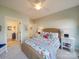 Bright bedroom with wicker headboard bed, colorful bedding, and an ensuite bathroom at 1140 Inlet Pointe Rd, Salisbury, NC 28146