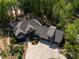 An elevated view showcasing the home's roof, three car garage, driveway, and meticulously landscaped front yard at 1140 Inlet Pointe Rd, Salisbury, NC 28146