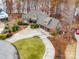 An elevated view showcasing the home's roof, three car garage, driveway, and meticulously landscaped front yard at 1140 Inlet Pointe Rd, Salisbury, NC 28146