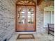 A stylish front entrance with stone and brick exterior, a wood door, and a quaint welcome mat at 1140 Inlet Pointe Rd, Salisbury, NC 28146