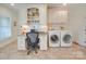 Laundry room with built in desk and cabinets and a washer and dryer at 1140 Inlet Pointe Rd, Salisbury, NC 28146