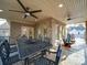 Covered patio with outdoor dining set, ceiling fans, and brick exterior at 1140 Inlet Pointe Rd, Salisbury, NC 28146