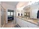 Double vanity bathroom with granite countertops and a view into a bedroom at 2353 Abundance Ln, Waxhaw, NC 28173