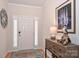 Front entry with stylish console table, hardwood floors, and plantation shutters at 2353 Abundance Ln, Waxhaw, NC 28173
