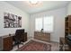 Home office with built-in shelving, hardwood floors and window with plantation shutters at 2353 Abundance Ln, Waxhaw, NC 28173