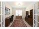 Home office with built-in shelving, hardwood floors and large window with plantation shutters at 2353 Abundance Ln, Waxhaw, NC 28173