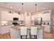 Modern kitchen with white cabinets, granite counters, and a large island at 2353 Abundance Ln, Waxhaw, NC 28173