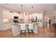 Modern kitchen with white cabinets, granite counters, and a large island at 2353 Abundance Ln, Waxhaw, NC 28173
