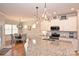 Modern kitchen island with granite countertops and stainless steel appliances at 2353 Abundance Ln, Waxhaw, NC 28173