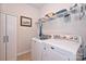 Bright laundry room features washer, dryer, and ample shelving at 2353 Abundance Ln, Waxhaw, NC 28173