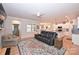 Open living room showcasing a leather couch, hardwood floors, and access to the kitchen at 2353 Abundance Ln, Waxhaw, NC 28173