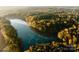 Scenic aerial view of a beautiful lake surrounded by colorful trees at 3034 Finchborough Ct # 233, Charlotte, NC 28269