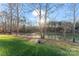 Landscaped backyard with pond and beautiful trees at 310 Pine St, Locust, NC 28097
