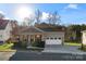 Craftsman style home with two-car garage and landscaped yard at 310 Pine St, Locust, NC 28097