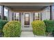 Inviting front entry with covered porch and lush landscaping at 310 Pine St, Locust, NC 28097