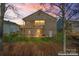 Two-story house exterior at dusk, showing deck and backyard at 310 Pine St, Locust, NC 28097