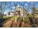 Two-story house with deck, surrounded by trees at 310 Pine St, Locust, NC 28097