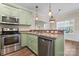 Modern kitchen with stainless steel appliances and green cabinets at 310 Pine St, Locust, NC 28097