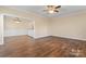 Open living area with hardwood floors and access to kitchen at 310 Pine St, Locust, NC 28097