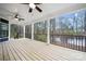 Spacious covered back porch offering serene views of a lush, wooded landscape and glistening pond at 357 Triple Ponds Ct, Clover, SC 29710