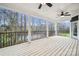 Covered back porch with black railing overlooking a tranquil waterfront view at 357 Triple Ponds Ct, Clover, SC 29710