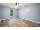Bright bedroom featuring a ceiling fan, vinyl flooring, and a large window at 357 Triple Ponds Ct, Clover, SC 29710