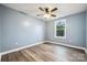 Cozy bedroom showcases hardwood floors, a ceiling fan, and a bright window with a green view at 357 Triple Ponds Ct, Clover, SC 29710