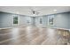 Bright, expansive bonus room featuring luxury vinyl plank flooring and multiple windows at 357 Triple Ponds Ct, Clover, SC 29710