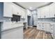 Well-lit kitchen with white cabinets, a backsplash, and modern countertops at 357 Triple Ponds Ct, Clover, SC 29710