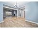 Bright, open-concept living room features modern lighting, fireplace, and light wood flooring at 357 Triple Ponds Ct, Clover, SC 29710