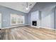 Spacious living room featuring wood-look flooring, a vaulted ceiling, and cozy fireplace, filled with natural light at 357 Triple Ponds Ct, Clover, SC 29710