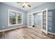 Bright room featuring wood-look floors, natural light, and a charming view from its expansive window at 357 Triple Ponds Ct, Clover, SC 29710