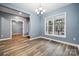 Inviting room highlighting contemporary wood-look flooring, a modern chandelier, and ample natural light at 357 Triple Ponds Ct, Clover, SC 29710