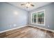 Neutral bedroom featuring durable wood-look vinyl floors and ample natural light from a large window at 357 Triple Ponds Ct, Clover, SC 29710