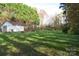 View of an open backyard with trees and a storage shed at 155 6Th Sw St, Taylorsville, NC 28681