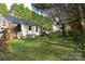 View of a spacious lawn with trees and shaded areas behind a single-story home at 155 6Th Sw St, Taylorsville, NC 28681