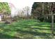 Open backyard featuring lush green grass, sparse trees, and old clotheslines at 155 6Th Sw St, Taylorsville, NC 28681