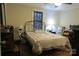 Cozy bedroom with wood floors, a metal frame bed, and a charming quilt at 155 6Th Sw St, Taylorsville, NC 28681