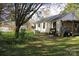 Back view of single story house with a mix of grass and shaded areas and an open deck at 155 6Th Sw St, Taylorsville, NC 28681