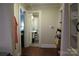 Hallway leading to a full bathroom featuring a pedestal sink and linoleum flooring at 155 6Th Sw St, Taylorsville, NC 28681